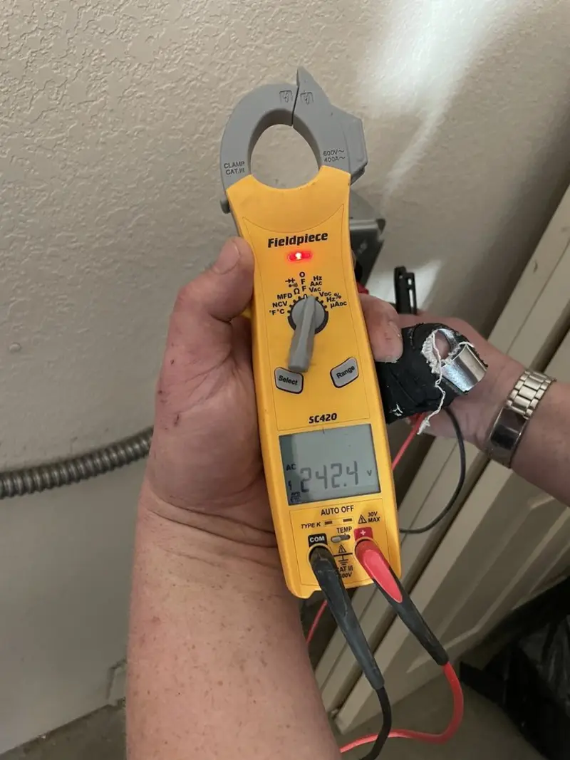 Voltage testing with clamp meter during Ceiling Fan Installation in Wappinger